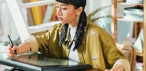 Zoe drawing on a pen display at her desk